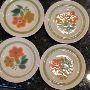 set of four Franciscan floral bread and butter plates. each has a flaw.